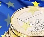 Picture showing one Euro coin with a the European flag in the background