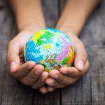 Person holding a globe
