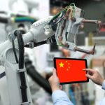 Engineer hand using tablet, heavy automation robot arm machine