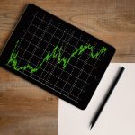 space-grey-ipad-air-with-graph-on-brown-wooden-table-187041