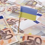 Flag of Ukraine sticking in 50 Euro banknotes