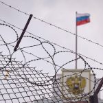 image: concept of European and US sanctions pressure on the Russian Federation government. flag of the Russian Federation in barbed wire, sanctions and aggression of Russia. Russian prison