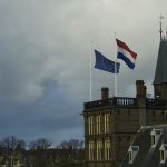 flags fly over the den haag parliament.
