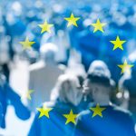 Crowd of people at the city and flag of EU, concept political picture.