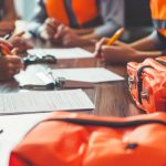 A crisis management team reviewing a checklist for disaster prep