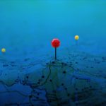 Pins on a geographic map curved like mountains. Pinning a locati