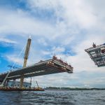 beautiful cable-stayed bridge in the construction process. summer. the view from the water